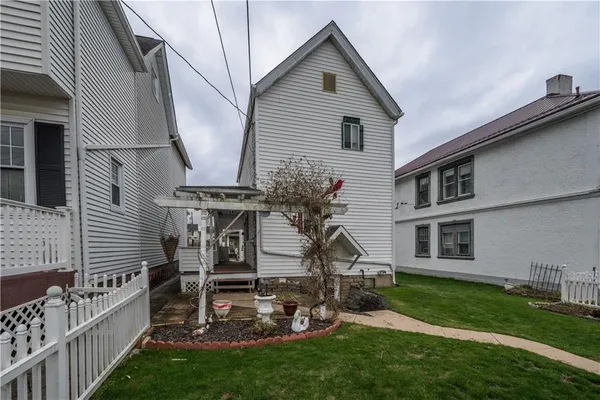 a view of a house with a yard and deck