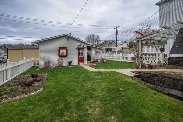 a view of a house with a yard and porch