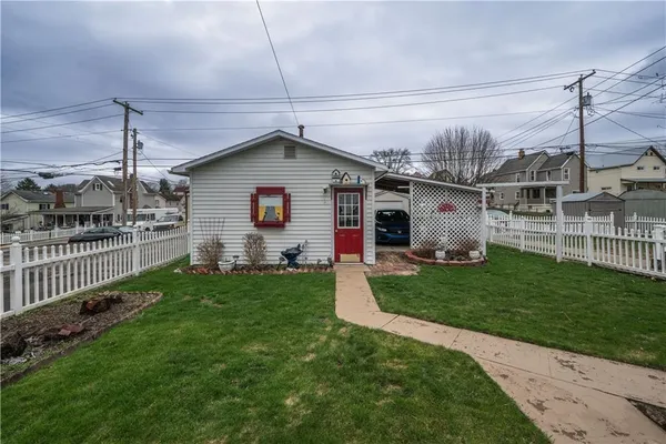 a front view of a house with a garden