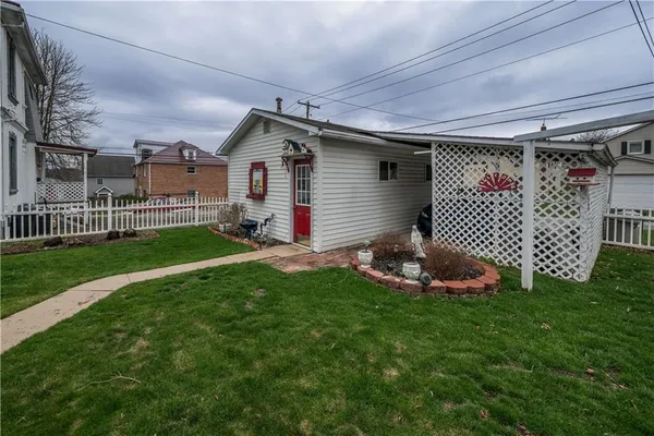 a front view of a house with a garden and yard