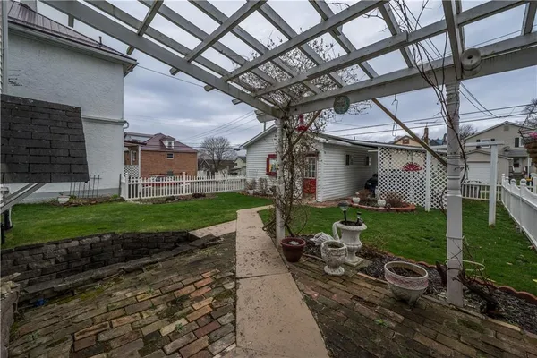 a view of a porch with furniture and a yard