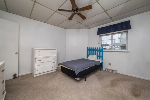 a room with a dresser and a window