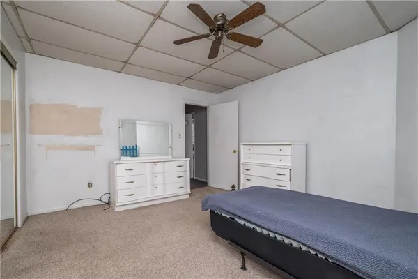 a bedroom with a bed and a dresser