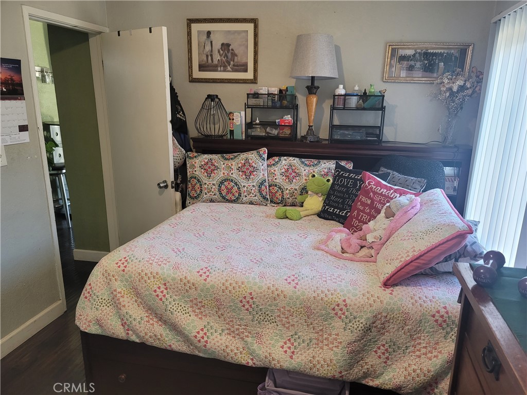 1408 South Burris Avenue Compton, CA 90221 - Photo 18 of 29 a bed sitting in a bedroom and painting on the wall