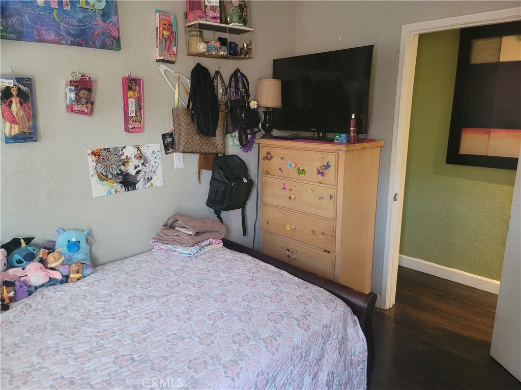 1408 South Burris Avenue Compton, CA 90221 - Photo 19 of 29 a bedroom with a bed and flat screen tv