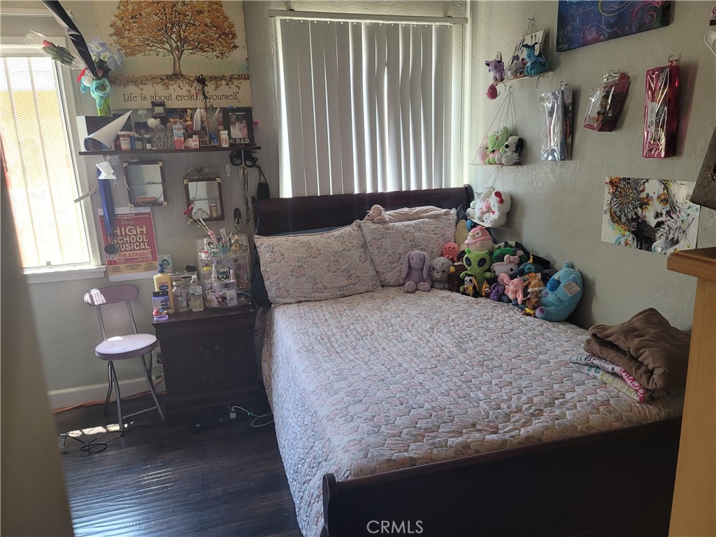 1408 South Burris Avenue Compton, CA 90221 - Photo 21 of 29 a bedroom with a bed and a table in it