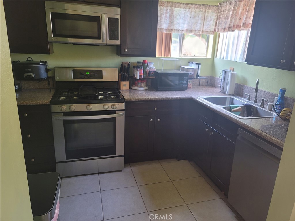 1408 South Burris Avenue Compton, CA 90221 - Photo 29 of 29 a kitchen with a stove sink and microwave