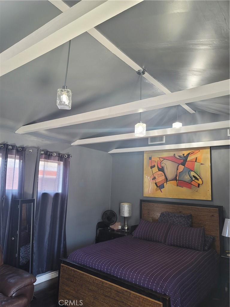 1408 South Burris Avenue Compton, CA 90221 - Photo 10 of 29 a bedroom with furniture and a painting on the wall