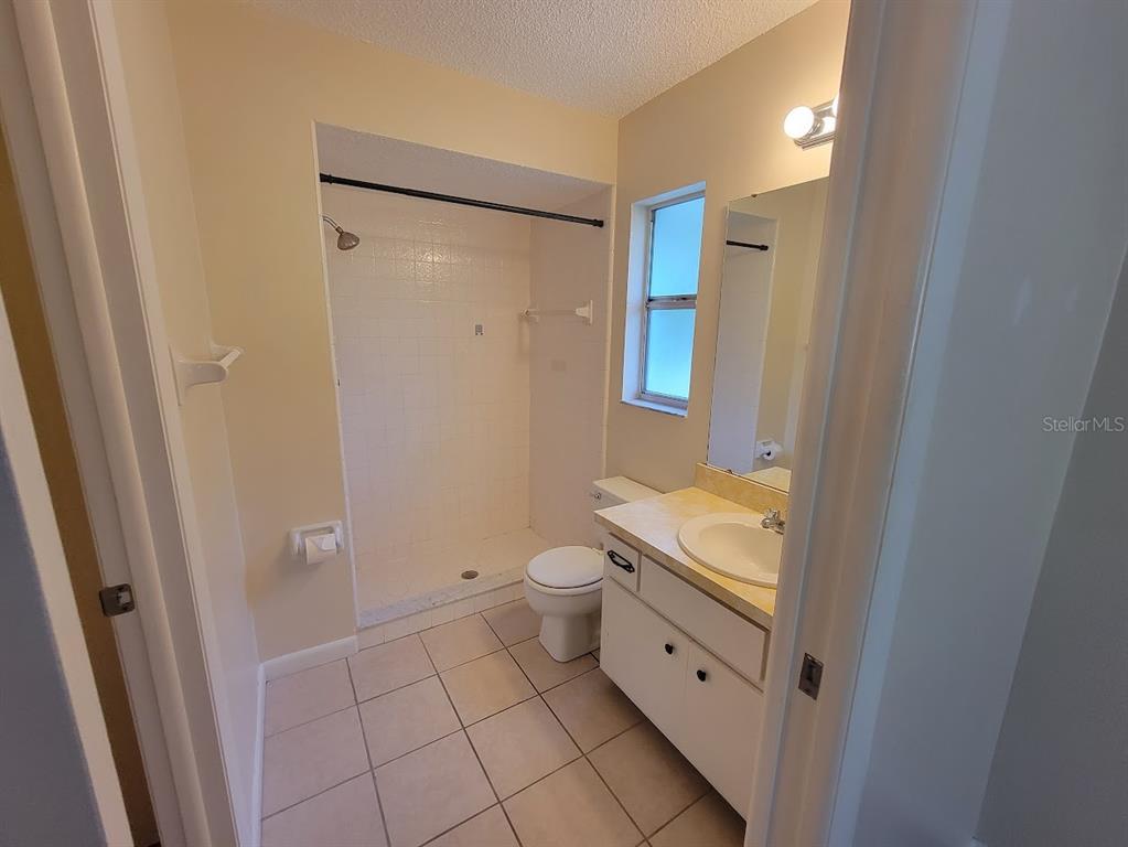 23358 Racine Avenue Punta Gorda, FL 33980 - Photo 15 of 28 a bathroom with a granite countertop sink toilet and shower