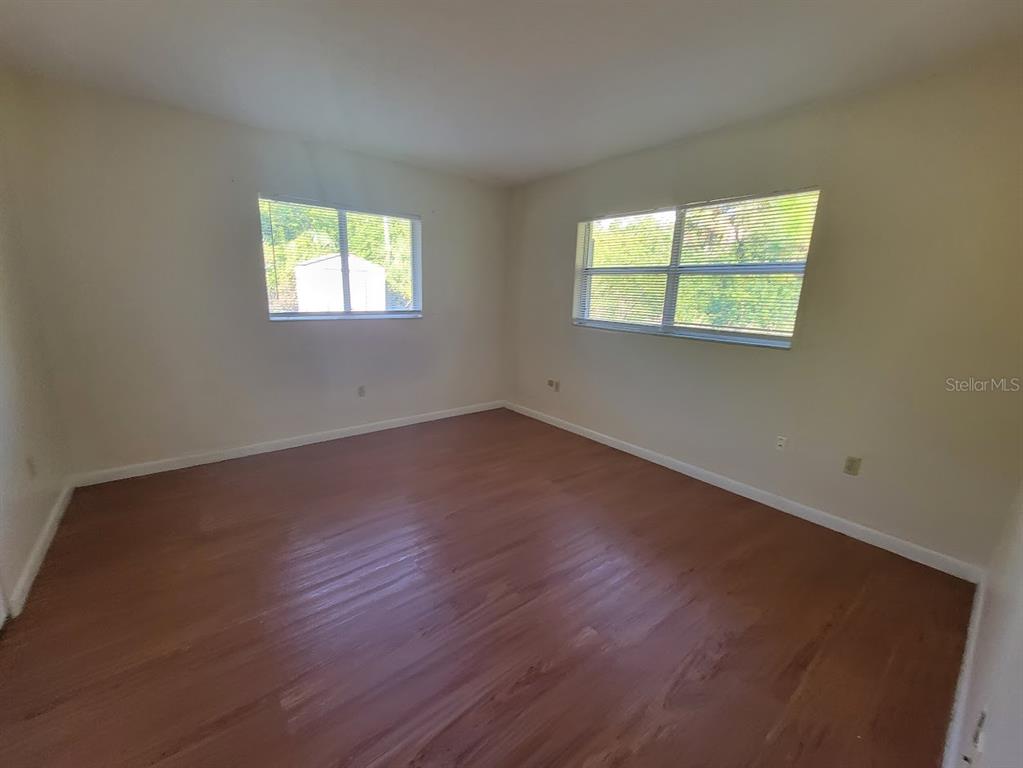 23358 Racine Avenue Punta Gorda, FL 33980 - Photo 16 of 28 a view of an empty room with wooden floor and a window