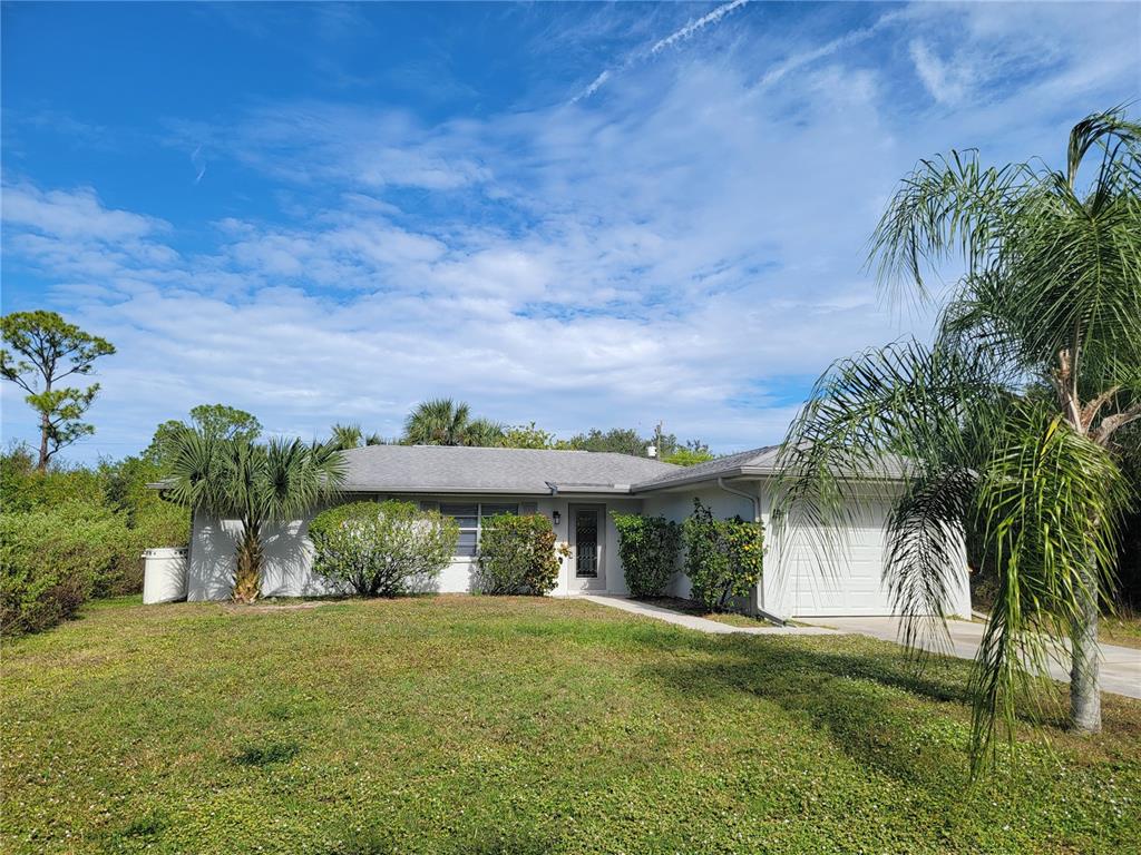 23358 Racine Avenue Punta Gorda, FL 33980 - Photo 28 of 28 a front view of a house with a yard and potted plants