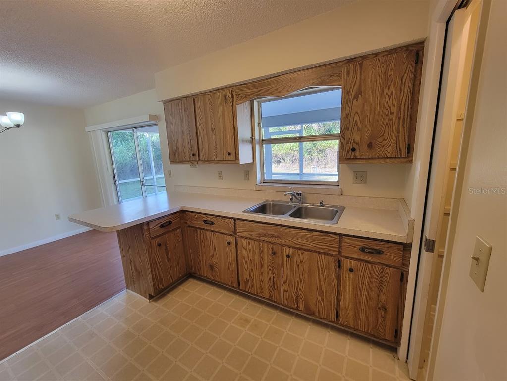 23358 Racine Avenue Punta Gorda, FL 33980 - Photo 3 of 28 a kitchen with sink cabinets and window