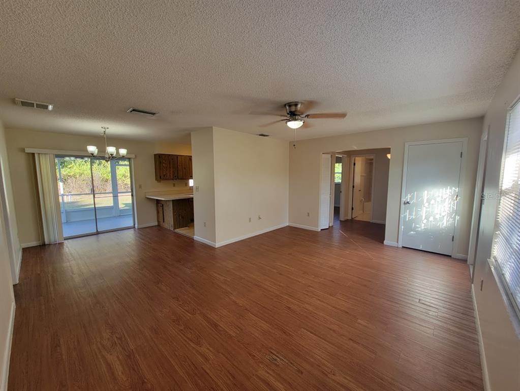 23358 Racine Avenue Punta Gorda, FL 33980 - Photo 4 of 28 a view of an empty room with window and wooden floor