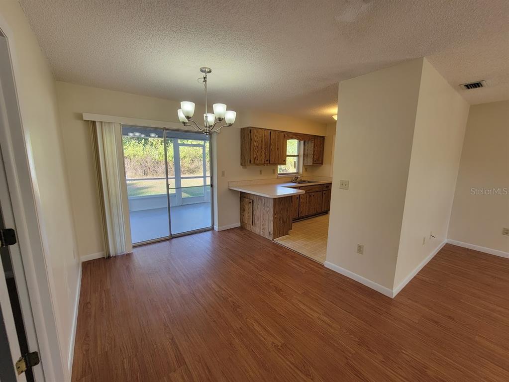 23358 Racine Avenue Punta Gorda, FL 33980 - Photo 8 of 28 wooden floor in an empty room with a window