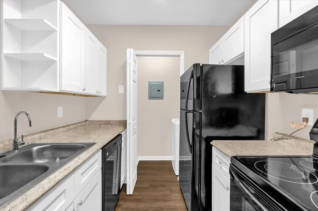 a kitchen with a sink and a refrigerator
