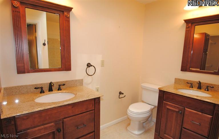 4846 Ranchwood Road Akron, OH 44333 - Photo 11 of 23 Separate cherry vanities with granite tops accent the totally remodeled master bath.