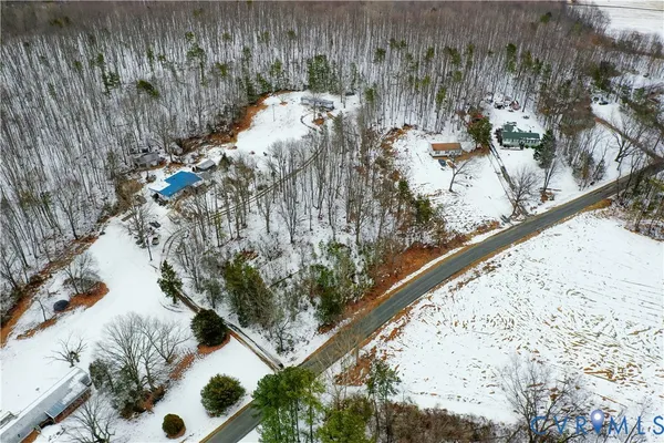 a view of a yard with plants and wooden fence