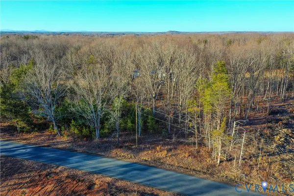 a view of a yard with wooden fence