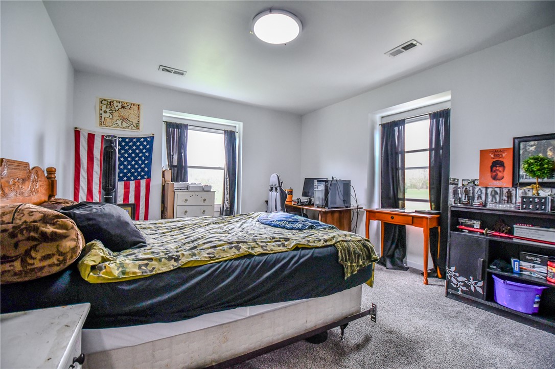 6169 Dayton Farmersville Road Dayton, OH 45417 - Photo 36 of 64 This spacious bedroom offers ample natural light and plush carpeting for comfort.