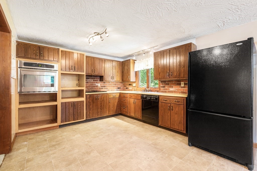 96 Fowler Road Northbridge, MA 01534 - Photo 6 of 28 a kitchen with granite countertop stainless steel appliances and refrigerator