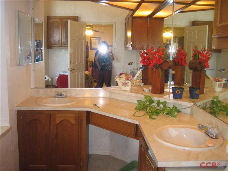 4750 South Blosser Road, Unit 318 Santa Maria, CA 93455 - Photo 17 of 17 a bathroom with a granite countertop sink a large mirror and a shower