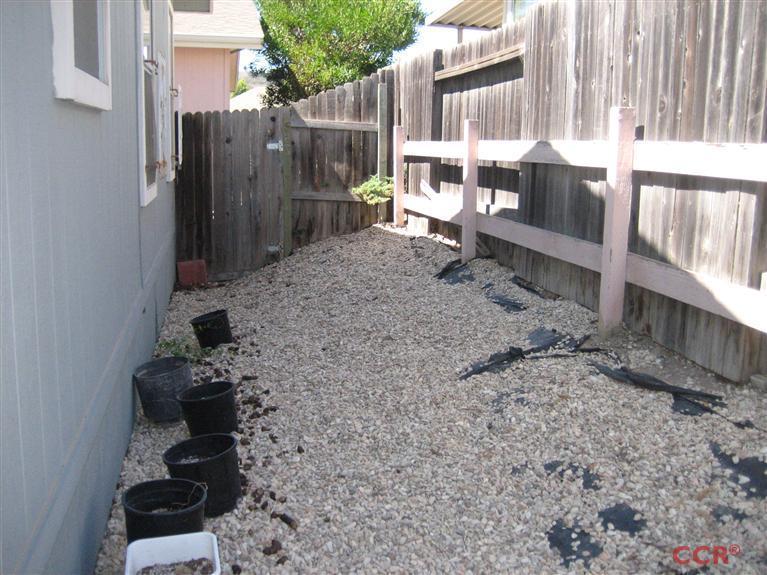 4750 South Blosser Road, Unit 318 Santa Maria, CA 93455 - Photo 6 of 17 a backyard of a house with table and chairs