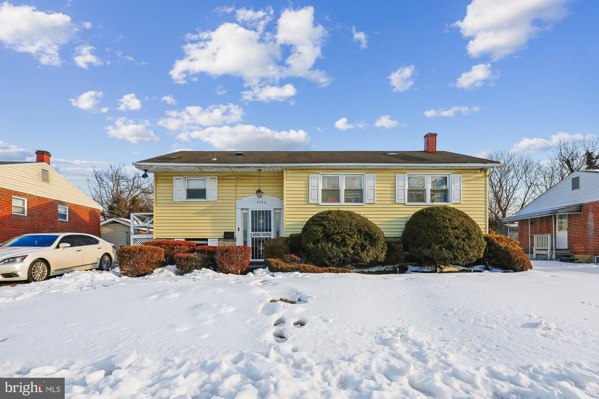3723 Eastman Road Randallstown, MD 21133 - Photo 1 of 36 a view of a blue house with a yard covered in snow