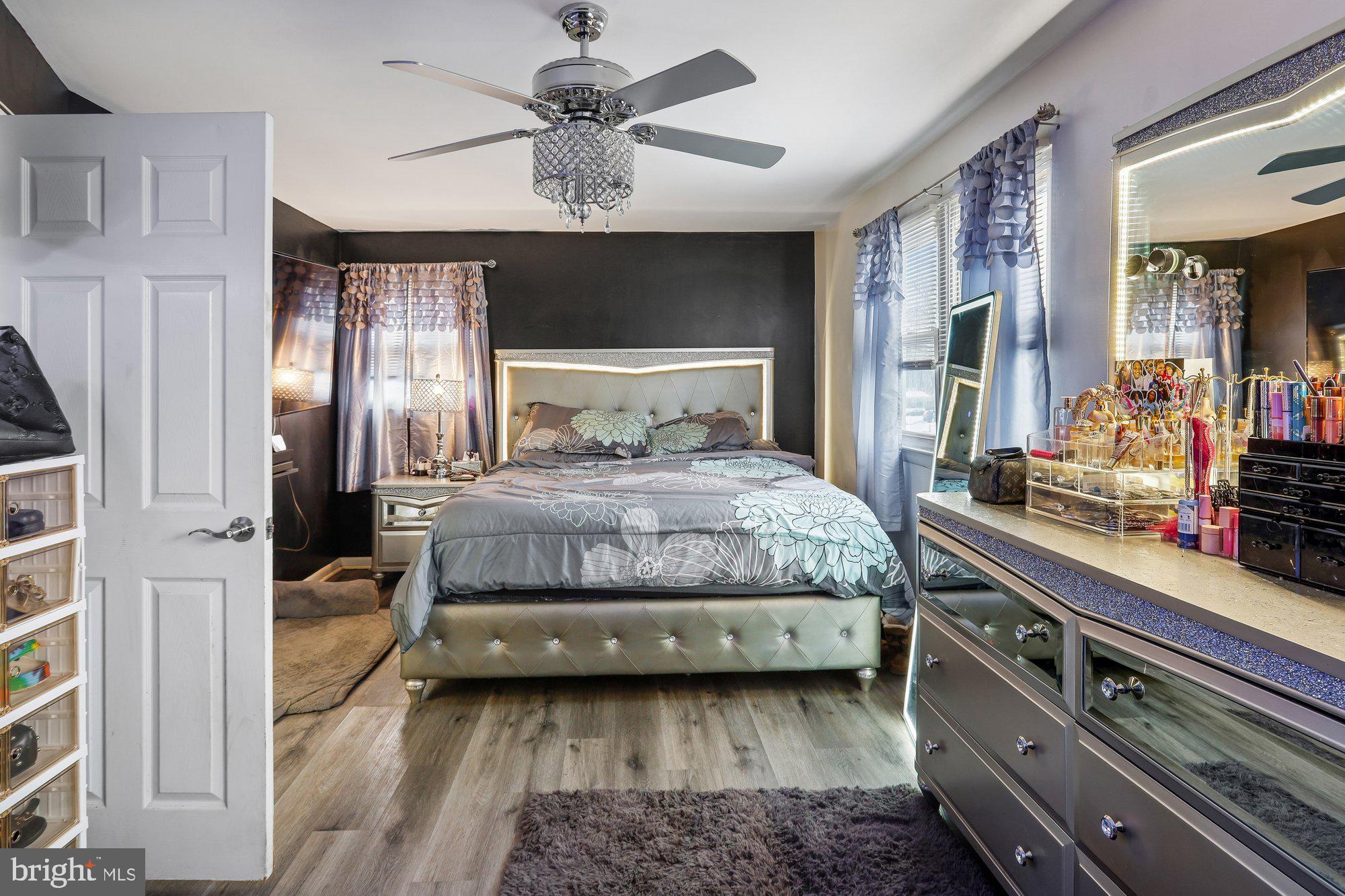 3723 Eastman Road Randallstown, MD 21133 - Photo 14 of 36 a bedroom with a large bed and a chandelier