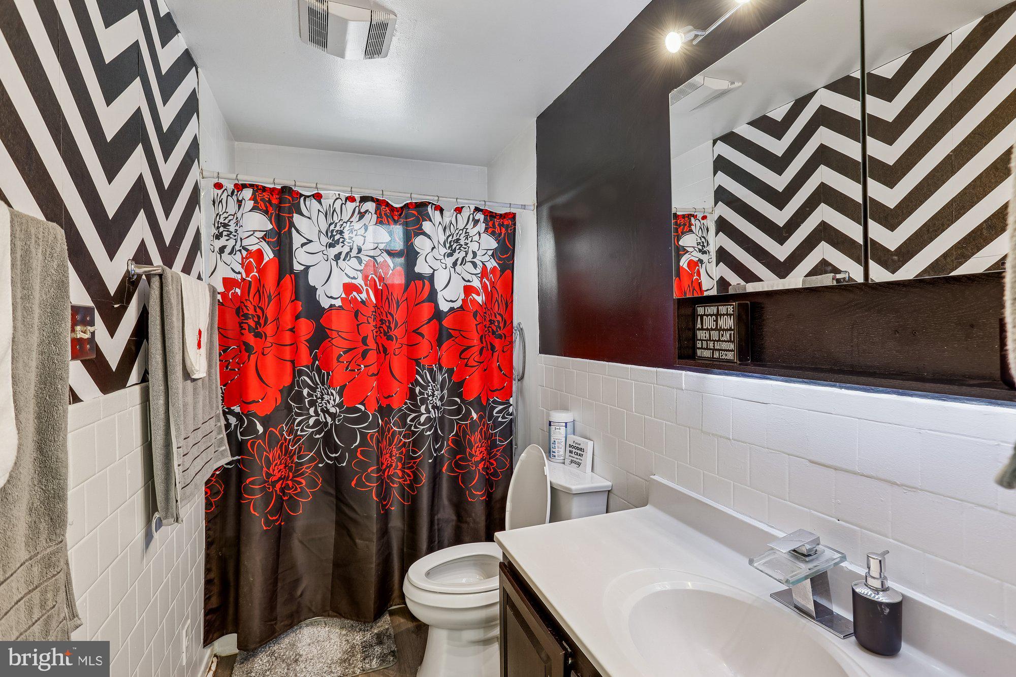 3723 Eastman Road Randallstown, MD 21133 - Photo 19 of 36 a bathroom with a sink toilet and shower curtain