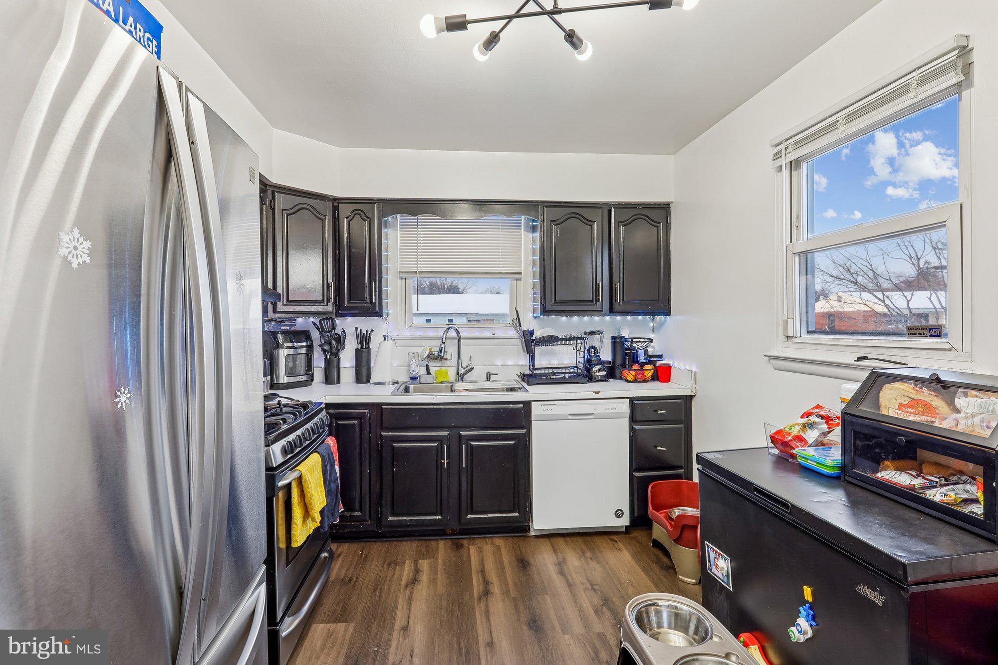 3723 Eastman Road Randallstown, MD 21133 - Photo 10 of 36 a kitchen with kitchen island a sink appliances and cabinets