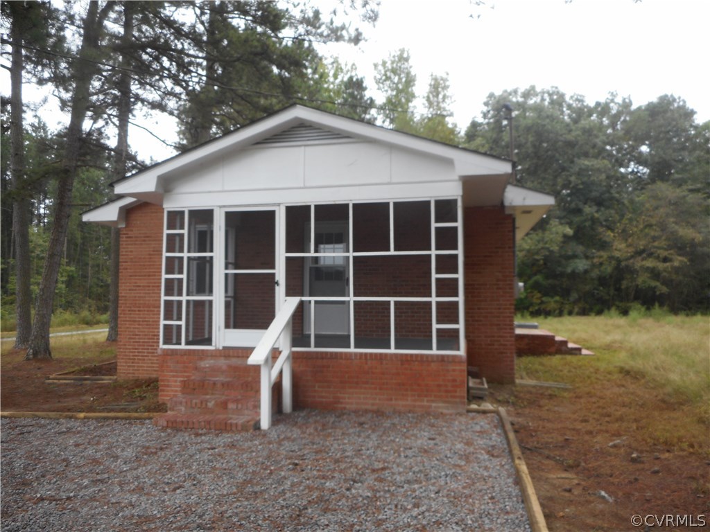 21469 Cabin Point Road Disputanta, VA 23842 - Photo 12 of 12 View of the screened porch, rear stoop, and new gr