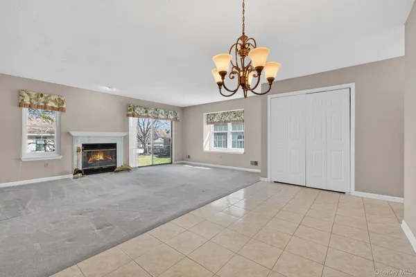 a view of a dining room with furniture and chandelier