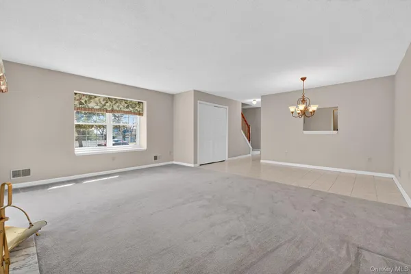 a living room with furniture fireplace and a large window