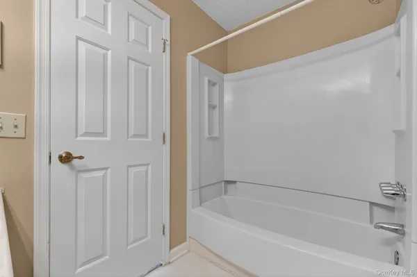 a spacious bedroom with a bed and a large window