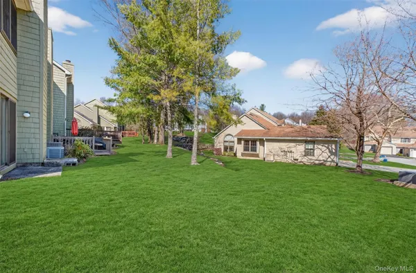 a front view of a house with a yard and potted plants