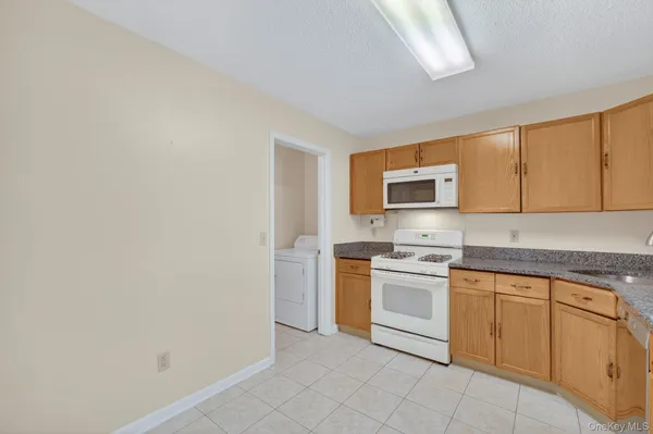a kitchen with a stove top oven sink and cabinets