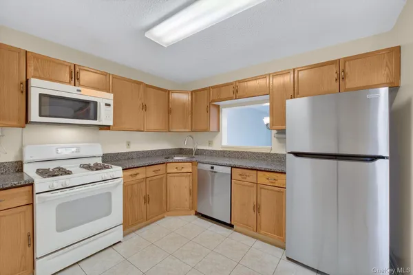 a kitchen with a refrigerator sink and microwave
