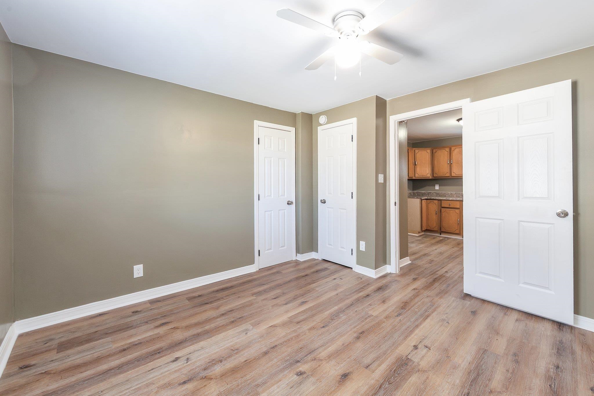 115 Carson Street Jackson, TN 38301 - Photo 13 of 14 wooden floor in an empty room with a window