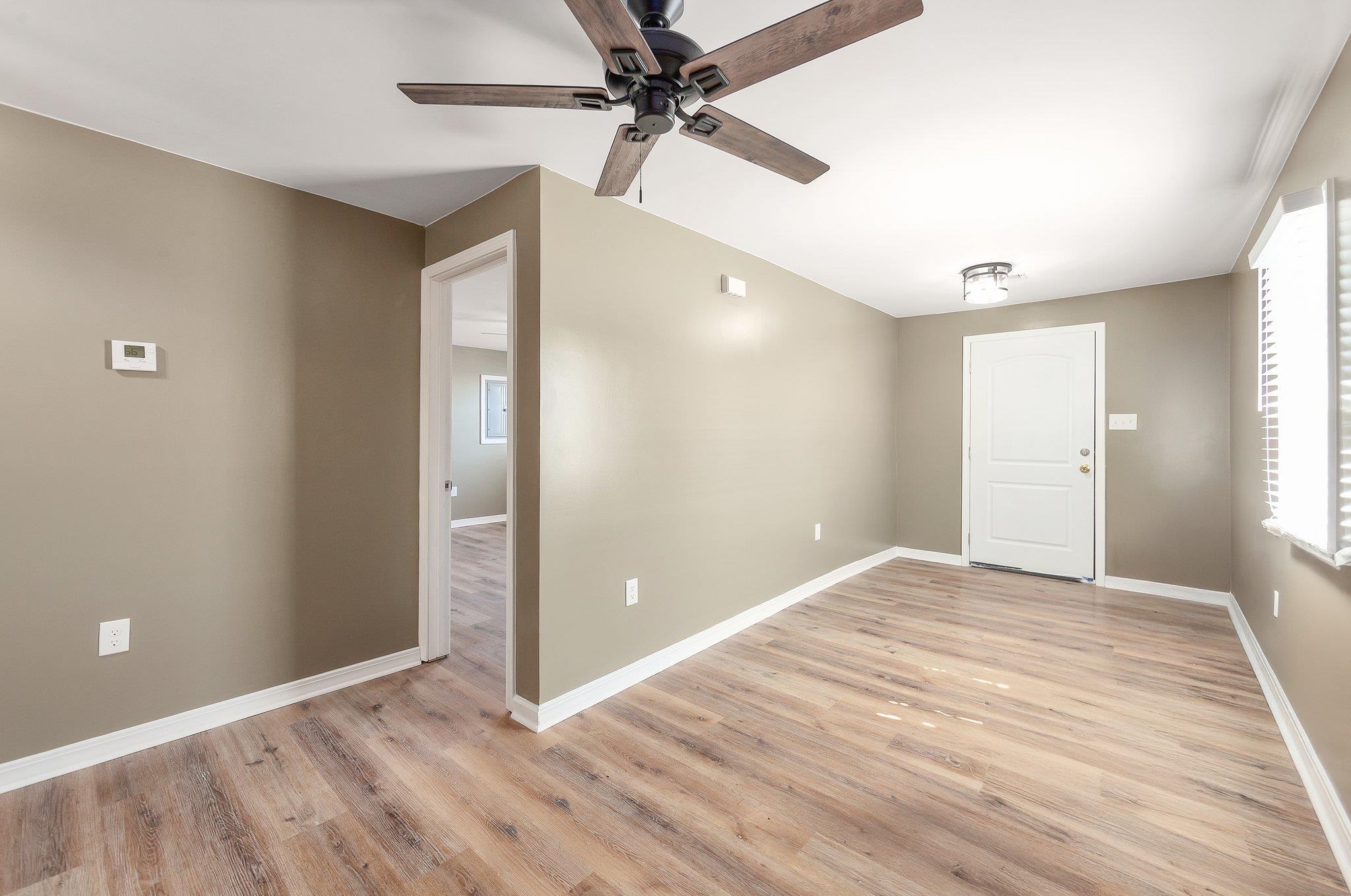 115 Carson Street Jackson, TN 38301 - Photo 5 of 14 wooden floor in an empty room with a window