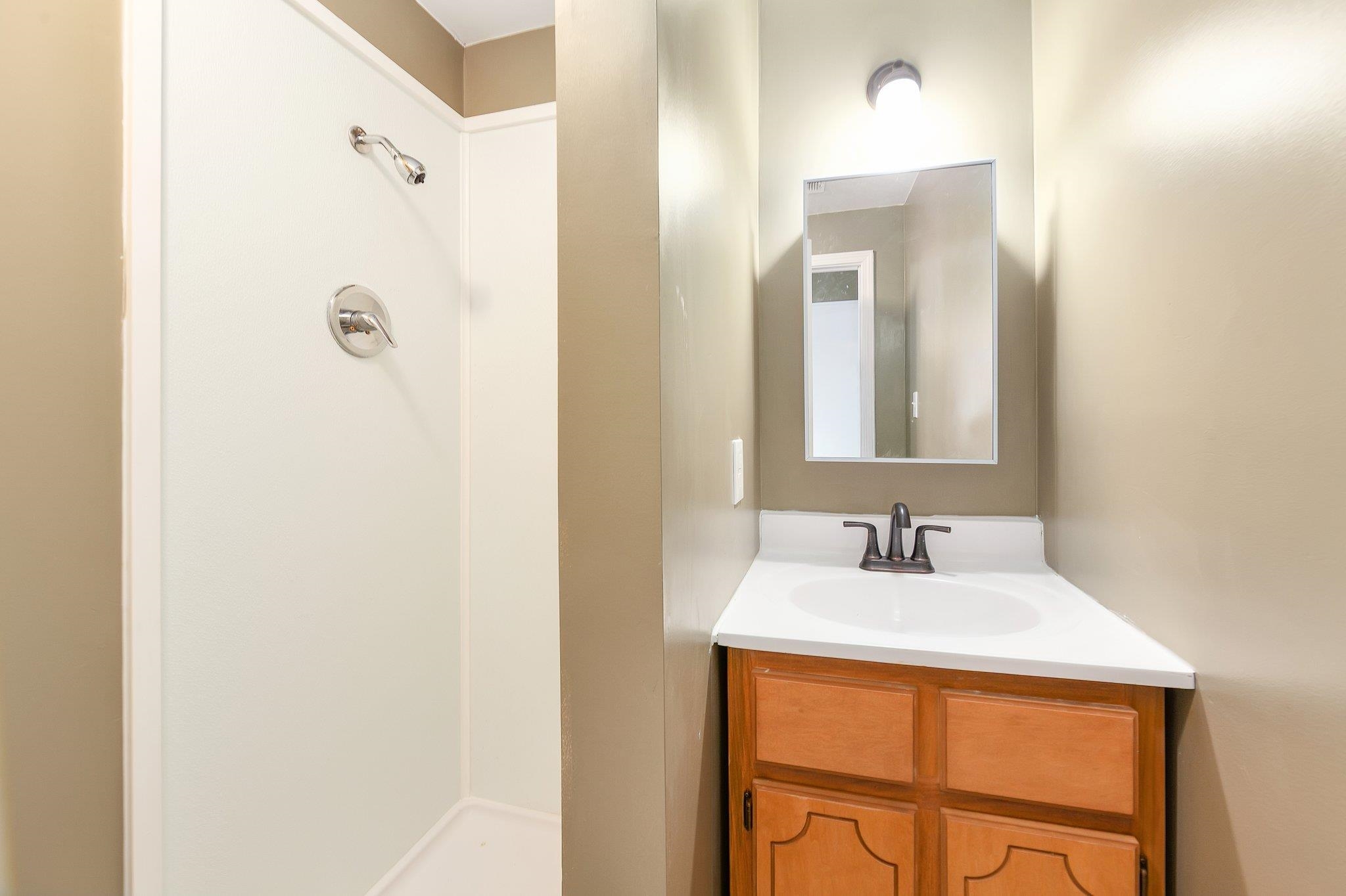 115 Carson Street Jackson, TN 38301 - Photo 6 of 14 a bathroom with a sink and a mirror