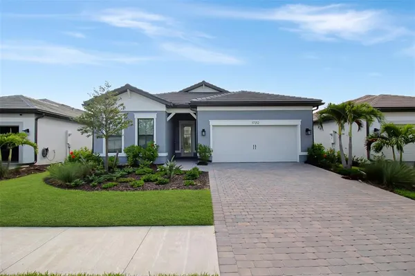 a front view of a house with a yard and garage