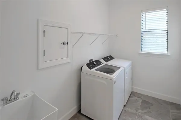 a large white kitchen with a large window