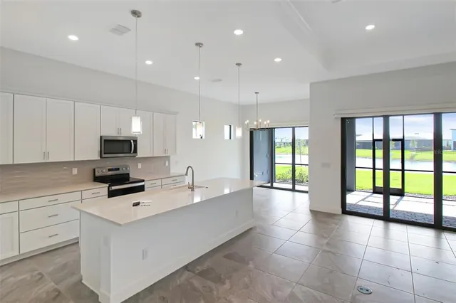 a kitchen with stainless steel appliances a refrigerator sink and stove