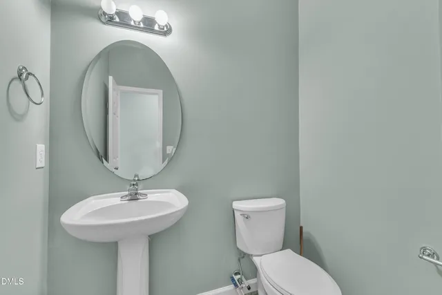 an empty room with wooden floor closet and windows