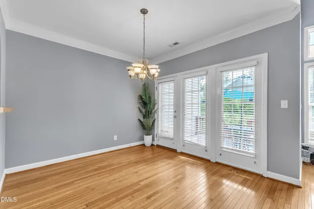 a kitchen with granite countertop white cabinets and a sink