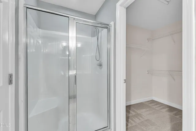 a spacious bathroom with a double vanity sink a mirror and a