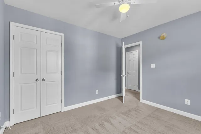 a view of an empty room and closet area