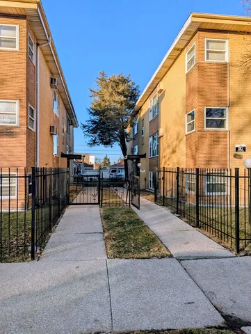 a view of a brick building next to a yard