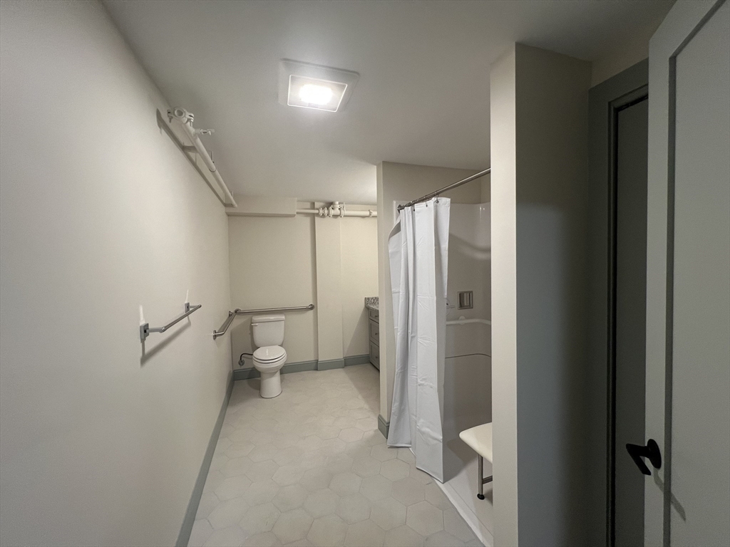 160 Seabury Street, Unit 18 Fall River, MA 02720 - Photo 8 of 11 a bathroom with a shower and a toilet
