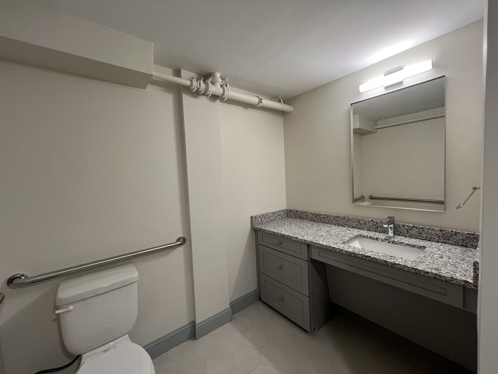 160 Seabury Street, Unit 18 Fall River, MA 02720 - Photo 9 of 11 a bathroom with a granite countertop sink toilet and shower